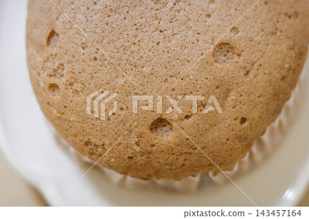 Close-up of the air bubbles and texture on the surface of a steamed bun. Close-up of the air bubbles and texture on the surface of a steamed bun. 143457164