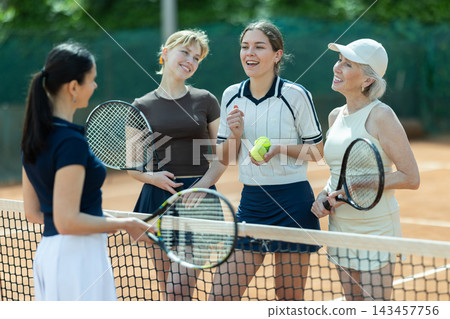 Tennis match female participants chat after game Tennis match female participants chat after game 143457756