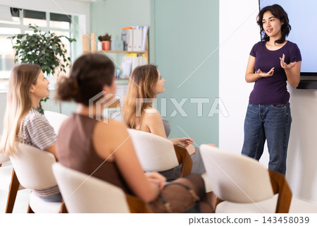 Young girl speaking to female audience during coaching session Young girl speaking to female audience during coaching session 143458039