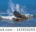 ocean waves crashing against jagged rocks 143458269