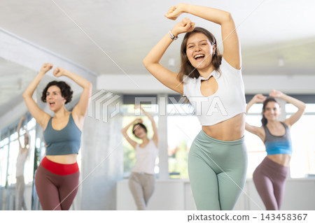 Dance class for adult people, positive women training in dance studio Dance class for adult people, positive women training in dance studio 143458367