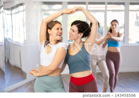 Paired dances of young girls during modern dance training in studio Paired dances of young girls during modern dance training in studio 143458506