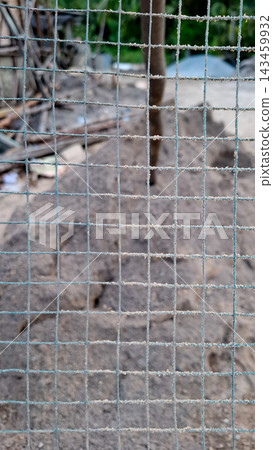 Wire Mesh Fence Grid Close Up With Construction Background Wire Mesh Fence Grid Close Up With Construction Background 143459932