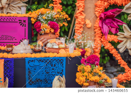 Flowers and food offerings decorating a traditional Mexican memorial altar. Flowers and food offerings decorating a traditional Mexican memorial altar. 143460655
