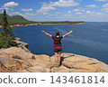 Teenager girl admiring the Aerial view of Sand Beach and Acadia National Park coastline from Otter Point Overlook, USA 143461814