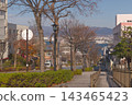 The beautiful cobblestone streets and scenery of Hachiman-zaka overlooking the autumn blue sky and Hakodate Port. 143465423