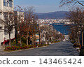 The spectacular view from Hachiman-zaka overlooking Hakodate Port and the mountains on the opposite shore on a clear autumn day. 143465424