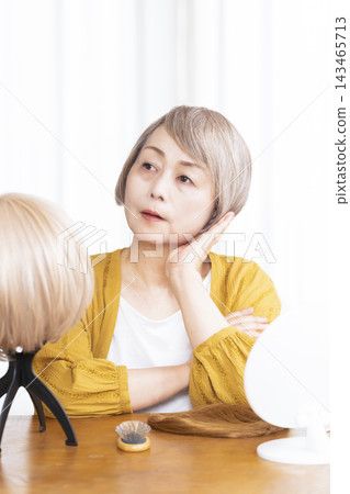 Senior women who wear wigs because they are worried about thinning hair Senior women who wear wigs because they are worried about thinning hair 143465713