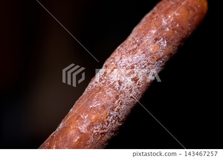 Macro close-up studio shot of a dry cured sausage with white mold coating Macro close-up studio shot of a dry cured sausage with white mold coating 143467257