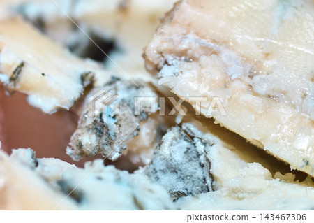 Extreme close-up shot of creamy blue cheese revealing intricate texture and mold patterns 143467306