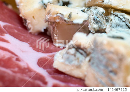 Close-up view of sliced blue cheese and cured meat on a plate Close-up view of sliced blue cheese and cured meat on a plate 143467315