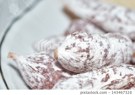 Close-up of traditional dry cured sausages covered in a natural layer of white mold. Close-up of traditional dry cured sausages covered in a natural layer of white mold. 143467328