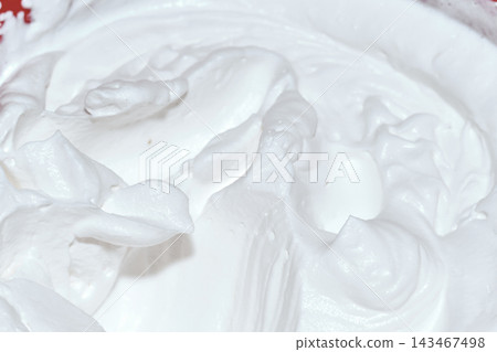 Close-up view of freshly whipped cream showing soft peaks and swirls Close-up view of freshly whipped cream showing soft peaks and swirls 143467498