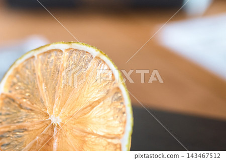 Close-up macro shot of a dried citrus fruit slice showing translucent pulp texture Close-up macro shot of a dried citrus fruit slice showing translucent pulp texture 143467512