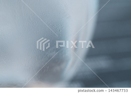 Close-up macro shot of condensation and tiny water droplets on a cold glass surface Close-up macro shot of condensation and tiny water droplets on a cold glass surface 143467733