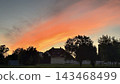 Red Sunset Sky Over Houses in a Small Town or Village 143468499