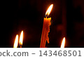 Burning Church Candles in Darkness Near the Altar 143468501