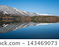 Autumn foliage and the Northern Alps reflected on the lake's surface: Lake Aoki, Nagano Prefecture 143469073