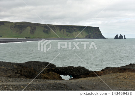 View of Reynisdrangar sea stacks and Reynisfjara beach from Dyrholaey Iceland View of Reynisdrangar sea stacks and Reynisfjara beach from Dyrholaey Iceland 143469428
