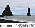 Volcanic Reynisdrangar sea stacks rising near Reynisfjara black sand beach Iceland 143469430