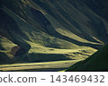 Sunlight and shadows on the green mountain ridges of Iceland 143469432