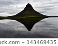 Water ripples breaking the reflection of Kirkjufell mountain, Iceland 143469435