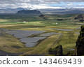 Distant glacier and vast green valley seen from Dyrholaey, Iceland 143469439