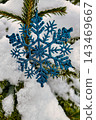 A tree is decorated for Christmas and New Year with snow covering its branches. The scene shows a winter landscape with festive decorations 143469667