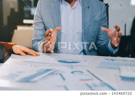 Business professional analyzing financial data on digital tablet dashboard with calculator and laptop, representing accounting software, ERP system integration, performance monitoring. Business professional analyzing financial data on digital tablet dashboard with calculator and laptop, representing accounting software, ERP system integration, performance monitoring. 143469720