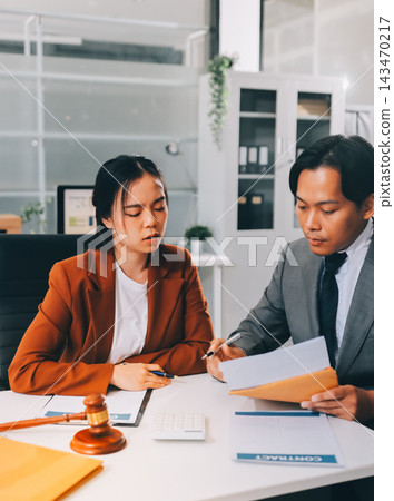 Businessmen or lawyers working together at a meeting, teamwork and partnership. Signing documents, contracts, checking details business agreement Businessmen or lawyers working together at a meeting, teamwork and partnership. Signing documents, contracts, checking details business agreement 143470217