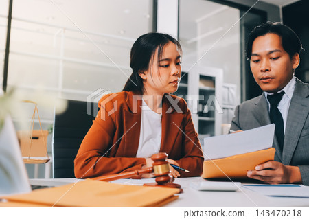 Businessmen or lawyers working together at a meeting, teamwork and partnership. Signing documents, contracts, checking details business agreement Businessmen or lawyers working together at a meeting, teamwork and partnership. Signing documents, contracts, checking details business agreement 143470218