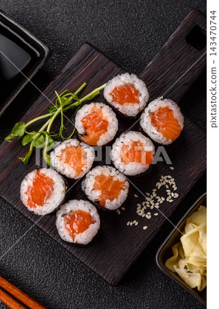 Sushi roll with tuna, rice, and cream cheese, served with soy sauce, wasabi, and ginger. Tuna roll Sushi roll with tuna, rice, and cream cheese, served with soy sauce, wasabi, and ginger. Tuna roll 143470744