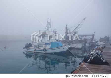 Fishing boats in the foggy harbor of Jaffa port. Israel Fishing boats in the foggy harbor of Jaffa port. Israel 143473772