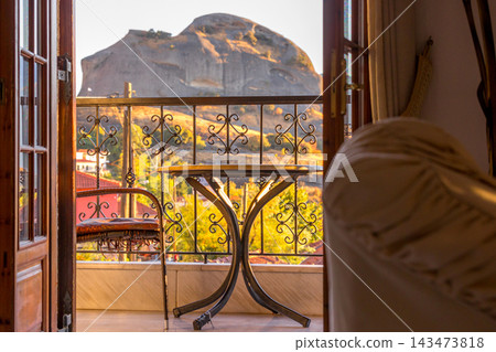 Kastraki Meteora Greece view of rock cliff from cozy balcony with table Kastraki Meteora Greece view of rock cliff from cozy balcony with table 143473818