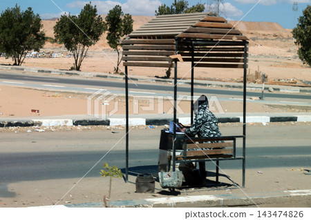Guard working at desert checkpoint booth 143474826