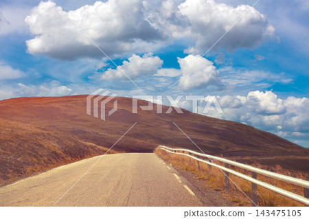 Driving a car on a mountain road. View from the windscreen. Beautiful harsh north minimalist landscape. Nature of Norway. Polar circle. The way to Nordkapp (North Cape). Norway Driving a car on a mountain road. View from the windscreen. Beautiful harsh north minimalist landscape. Nature of Norway. Polar circle. The way to Nordkapp (North Cape). Norway 143475105