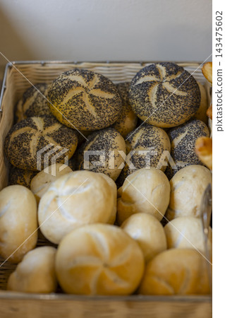 Kaiser rolls and bread buns in a basket Kaiser rolls and bread buns in a basket 143475602