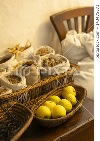 Quince fruits and dried herbs in traditional baskets Quince fruits and dried herbs in traditional baskets 143475673