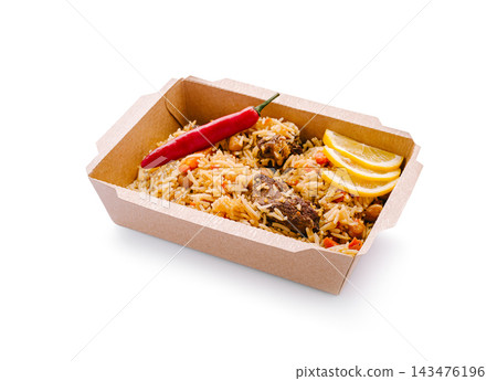 Beef pilaf with chili and lemon slices in takeout box Beef pilaf with chili and lemon slices in takeout box 143476196