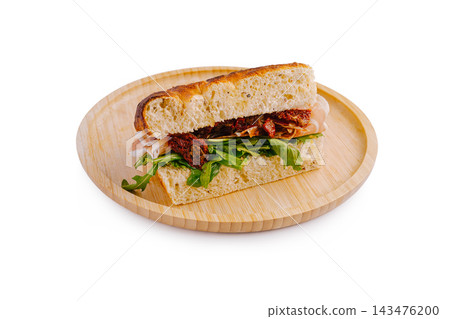 Focaccia sandwich with prosciutto, arugula, sun-dried tomatoes Focaccia sandwich with prosciutto, arugula, sun-dried tomatoes 143476200