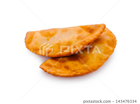 Two golden fried empanadas on white background Two golden fried empanadas on white background 143476334