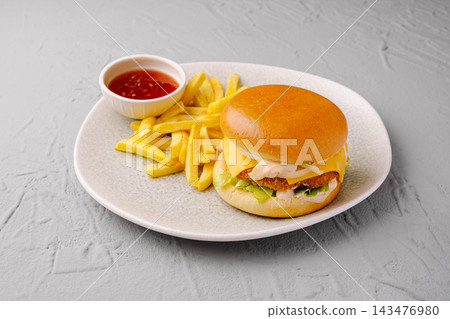 Chicken burger meal with french fries and chili sauce Chicken burger meal with french fries and chili sauce 143476980