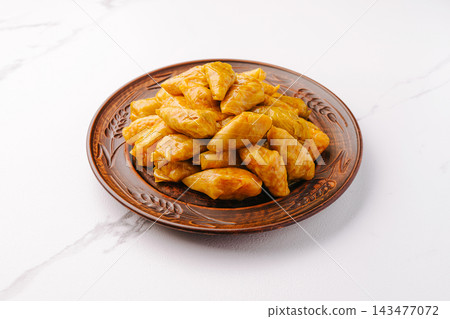 Cabbage rolls served on a brown plate 143477072