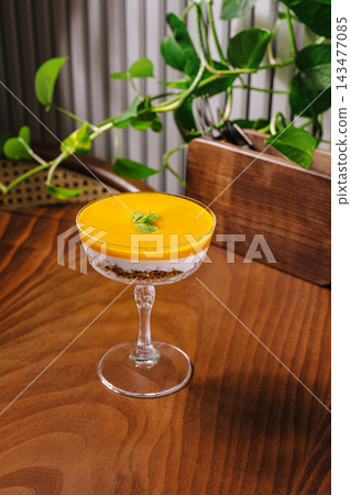 Mango parfait dessert with granola and mint leaf Mango parfait dessert with granola and mint leaf 143477085