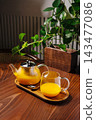 Sea buckthorn tea serving on wooden tray at home 143477086