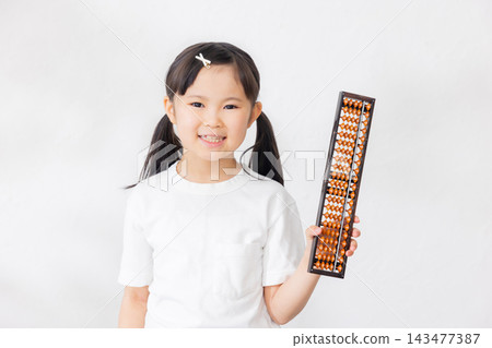 一名小學生拿著算盤 143477387