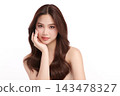 A beautiful young Asian woman with clean, fresh skin against a white background. Skincare, facial treatment, cosmetology, beauty, and spa. An elegant portrait of an Asian woman. 143478327