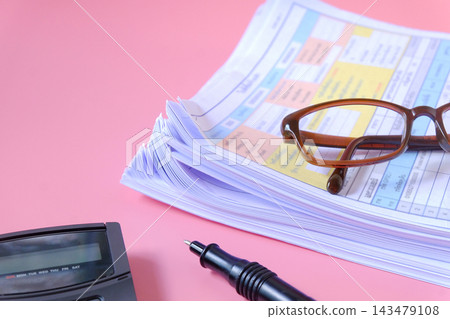 Stack of documents with calculator and pen on background. 143479108