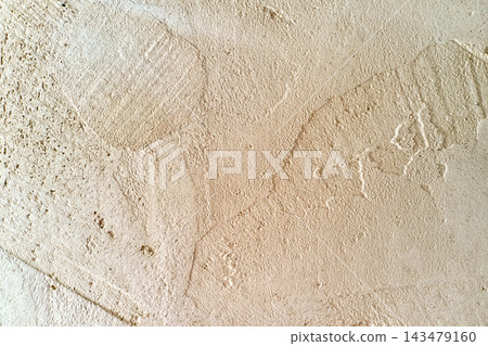 Beige plaster wall texture close-up with rough surface, shallow cracks, and faint stains, ideal background material for interior design and construction concepts Beige plaster wall texture close-up with rough surface, shallow cracks, and faint stains, ideal background material for interior design and construction concepts 143479160