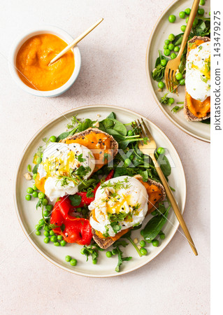 This meal features gluten free bread sandwiches topped with zucchini caviar and poached egg. It includes roasted red peppers and green peas, served with baked pears This meal features gluten free bread sandwiches topped with zucchini caviar and poached egg. It includes roasted red peppers and green peas, served with baked pears 143479275